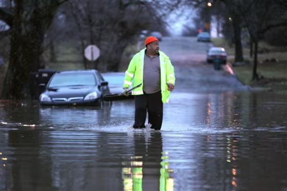 This road in Muncie, Ind., was among those flooded out on Monday. Resident Mark Coatie was attempting to clear drains near his house after the area received over three inches of rainfall.